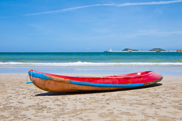 Red kayak on the beach with blue sky , Eastern of Thailand