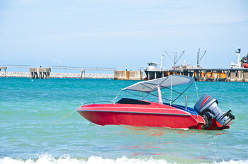 Red jet boat with jetty