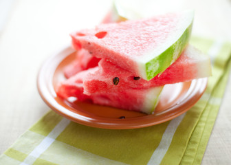 Watermelon on the brown circular plate