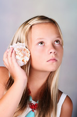 Young girl holding a seashell
