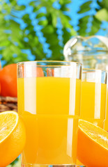Composition with two glasses of orange juice and fruits