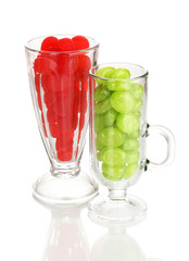 Color candies in glasses isolated on white