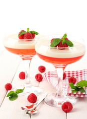fruit jelly with berries in glasses on wooden table