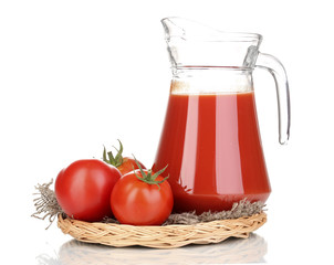 Tomato juice in pitcher on wicker mat isolated on white