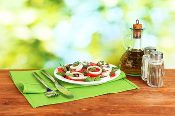 Salad with capers in the plate on bright green background