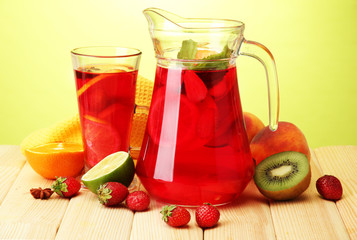 sangria in jar and glass with fruits,