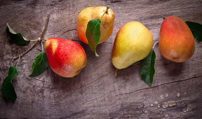 harvested pears on old wooden background