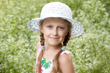 Charming blonde girl in a hat