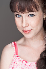 close-up portrait of a beautiful smiling girl with freckles