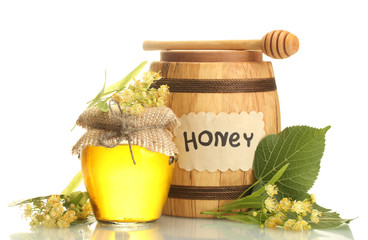 jar and barrel with linden honey and flowers isolated on white