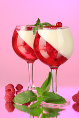 fruit jelly with berries in glasses on pink background