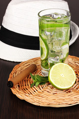 Mojito and a hat on a wooden background
