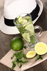 Mojito and a hat on a gray wooden background
