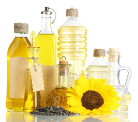 oil in bottles, sunflower and seeds, isolated on white