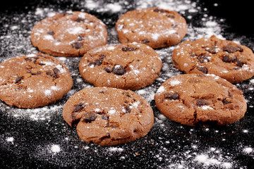 Chocolate chips cookies isolated on black