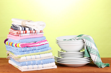 kitchen towels with dishes on green background close-up