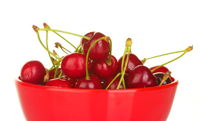 cherry in a red bowl on white background close-up
