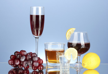 a variety of alcoholic drinks on blue background