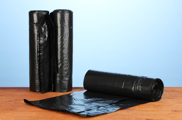 plastic garbage bags on blue background close-up