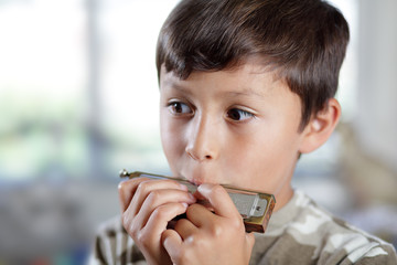 Boy playing harmonica