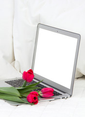 Modern popular laptop with tulips flowers