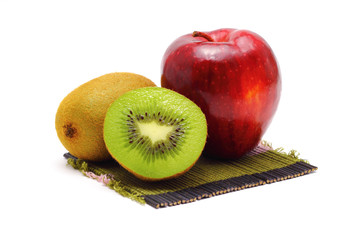 apple and kiwi fresh fruit on bamboo mats white background