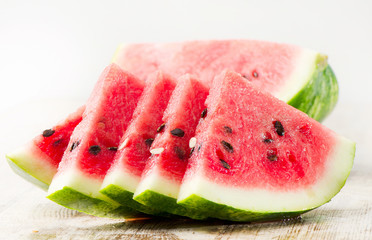 slices of watermelon on wooden table