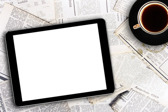 digital tablet and coffee cup on newspapers - Powered by Adobe
