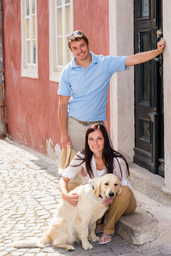 Young couple resting with dog on stairs