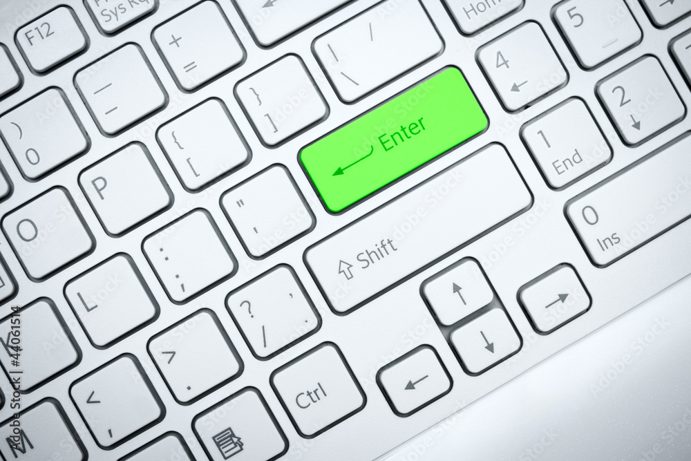 Fototapete computer keyboard with green button