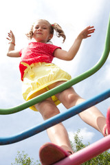 Girl with pigtails plays on the playground