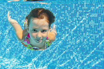 Happy underwater child in swimming pool, summer vacation, sport