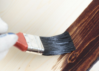 Varnishing a wooden shelf