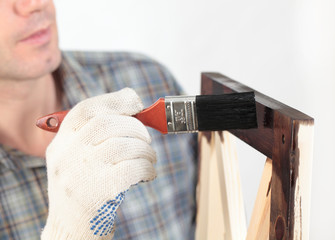 Varnishing a wooden part of furniture