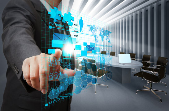 businessman hand point on virtual business network in board room