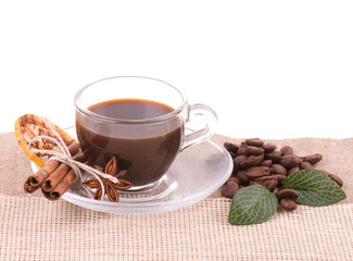Cup of coffee on coffee beans on white background