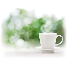 Cup of hot drink on defocus summer background