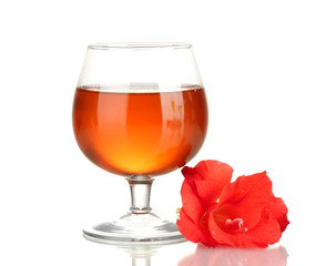glass with cocktail and gladiolus bud isolated on white