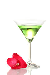 glass with cocktail and gladiolus bud isolated on white