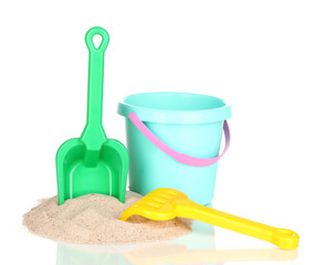 Children's beach toys and sand isolated on white