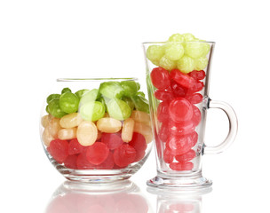 Color candies in glasses isolated on white