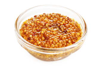 Mustard in grains in glass bowl isolated on white