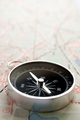 compass, map and pushpin on the table