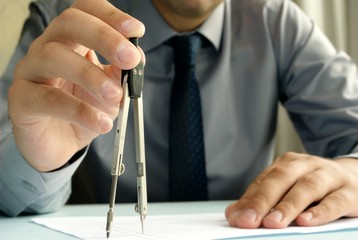 Engineer with a measuring compass in hand