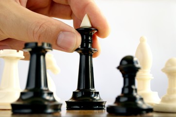 man playing chess, and shows the hand of chess pieces
