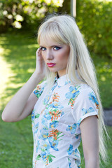 Portrait of a beautiful blonde woman in summer park