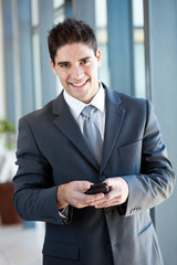 young businessman using smart phone sending emails