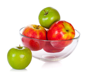 Glass bowl with apples isolated on white