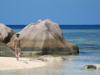 Marine biologist in professional clothing between granite rocks
