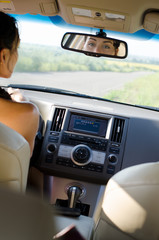 Woman driver looking in her rear view mirror